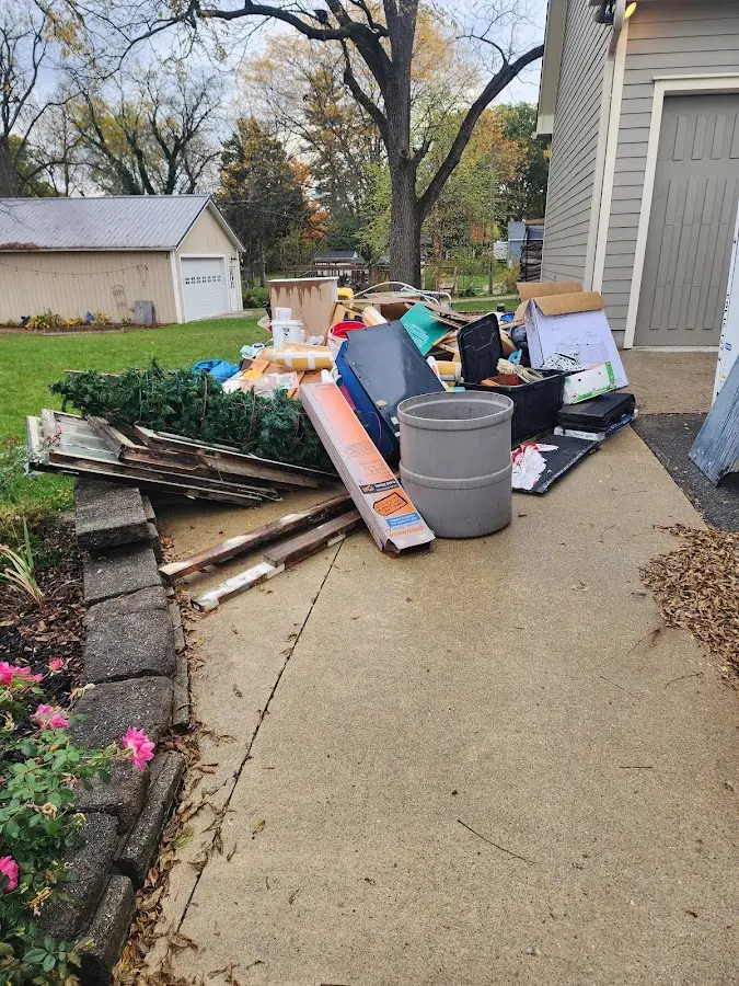 Dumpster being loaded with debris for Residential Dumpster Rental in Groton